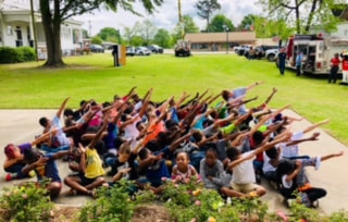 Photo of many children dabbing at Community Heroes Event